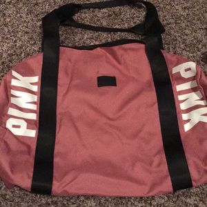 Rose colored mini duffel bag.